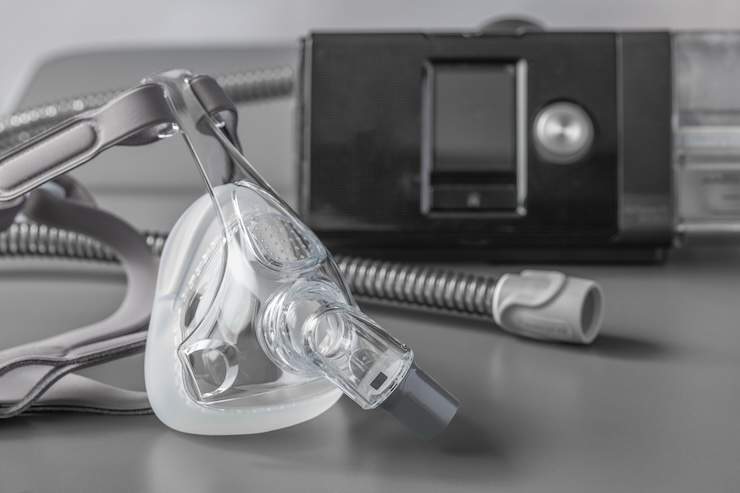 Sleep apnea CPAP mask on grey table