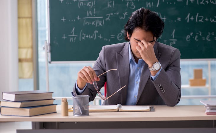 teacher tired at desk