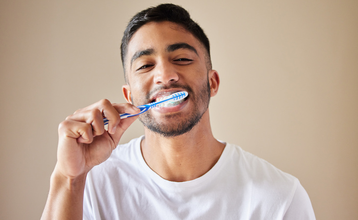 person brushing teeth at night