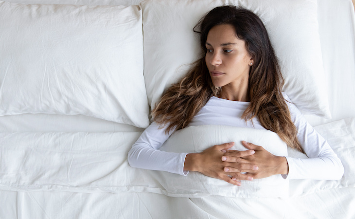 person doing cognitive shuffling in bed to fall asleep