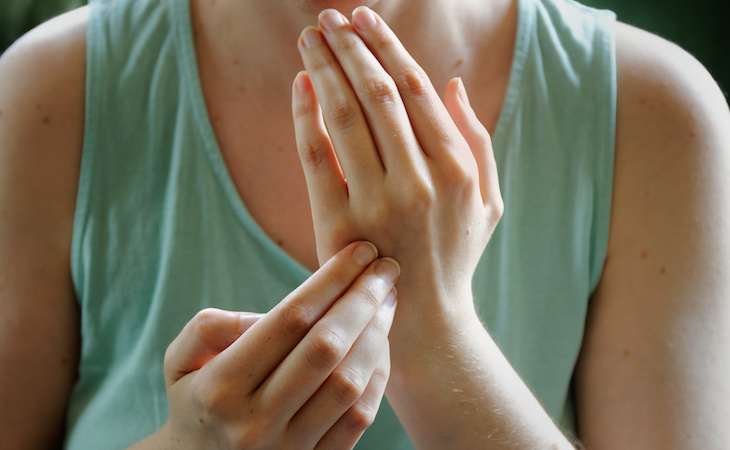 person practicing eft on hand