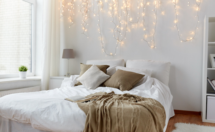 bedroom decorated with holiday lights