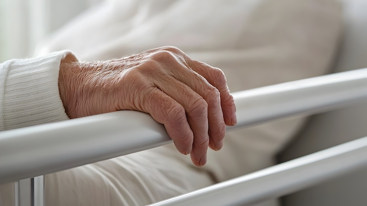 hand holding bed rail