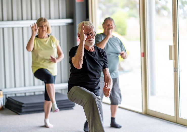 group of older adults doing tai chi