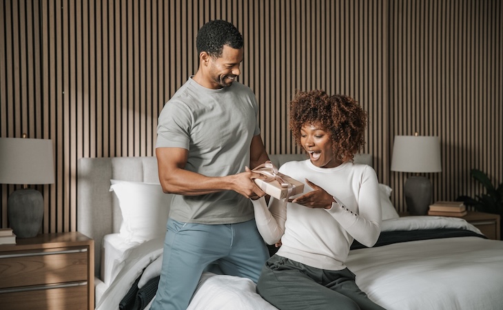 couple opening a holiday sleep gift